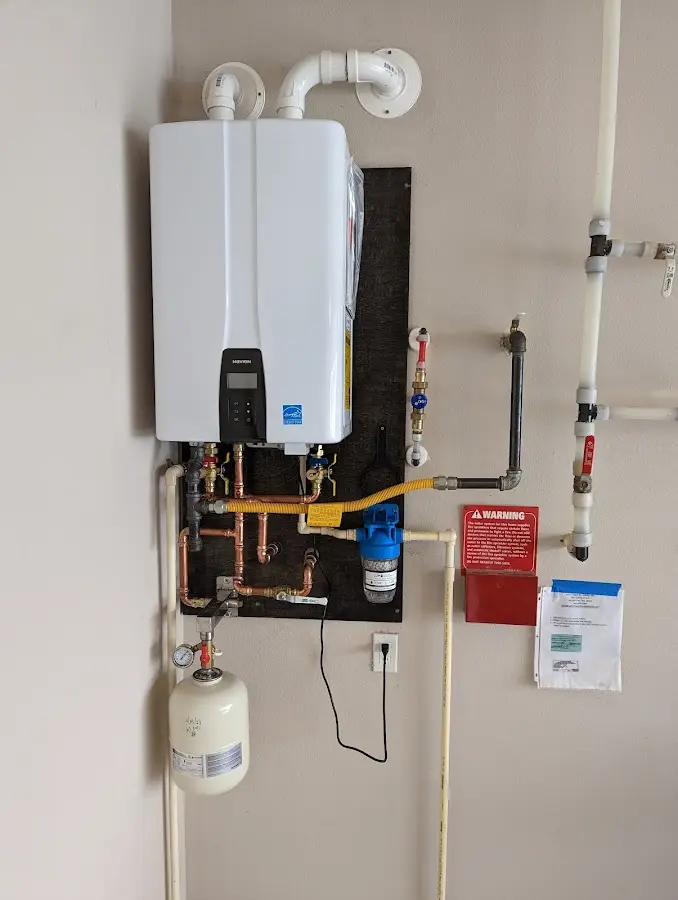 Professional plumber installing copper piping in a Lansford home